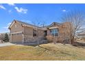 Charming single-story home featuring a two-car garage and well-manicured lawn at 4561 Hope Cir, Broomfield, CO 80023