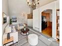 Bright living room with vaulted ceiling, fireplace and kitchen views at 2020 Alpine Dr, Erie, CO 80516