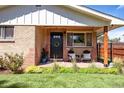 Inviting front porch with chairs, black door and brick exterior, great for relaxing at 4585 Hooker St, Denver, CO 80211