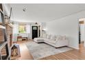 Bright living room with fireplace, hardwood floors and large windows, a cozy gathering space at 4585 Hooker St, Denver, CO 80211