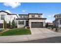 Charming two-story home with a well-manicured lawn and a two-car garage at 9724 Cantabria Pt, Lone Tree, CO 80124