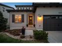 Inviting front entrance with elegant landscaping and a charming front door at 9724 Cantabria Pt, Lone Tree, CO 80124