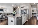 Bright, modern kitchen featuring an island with granite countertops, stainless steel appliances, and hardwood floors at 9724 Cantabria Pt, Lone Tree, CO 80124