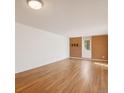 Open living room with plenty of space, featuring laminate flooring and brick accent wall at 2880 S Locust St # 109S, Denver, CO 80222