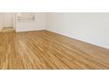 A well-lit open living room featuring updated laminate flooring at 2880 S Locust St # 109S, Denver, CO 80222