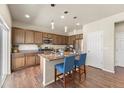 Bright kitchen features stainless appliances, granite countertops, pendant lighting, and breakfast bar seating at 19131 E 65Th Ave, Denver, CO 80249