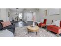 Bright living room featuring new floors, modern decor, and a cozy seating arrangement with stylish accents at 3402 S Olathe Way, Aurora, CO 80013