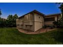 The backyard features well-maintained lawn, mature trees, rock features and a covered patio at 6379 Spotted Fawn Run, Littleton, CO 80125