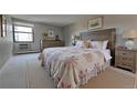 Cozy bedroom with a large floral patterned quilt, wooden headboard, and natural light at 13991 E Marina Dr # 505, Aurora, CO 80014