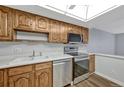 The kitchen features ample cabinetry, stainless steel appliances, and wood-look floors at 13991 E Marina Dr # 505, Aurora, CO 80014