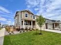 Beautiful two-story home with a spacious lawn, a charming front porch, and a well-manicured garden at 24707 E 40Th Ave, Aurora, CO 80019