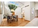 Elegant dining area with a modern table set, high ceilings, and a unique indoor tree feature at 6305 W 6Th Ave # C17, Lakewood, CO 80214