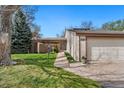 Charming home featuring a landscaped front yard, covered entry, and an attached two-car garage at 6305 W 6Th Ave # C17, Lakewood, CO 80214