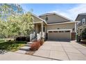 Charming home featuring a well-kept lawn, inviting porch, and a two-car garage at 827 Sundance Ln, Erie, CO 80516