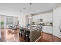 Modern kitchen featuring an island with barstool seating, stainless appliances, and pendant lights at 827 Sundance Ln, Erie, CO 80516