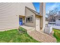 Inviting front entrance with blue door and colorful flower bed at 8008 W Spanish Peak, Littleton, CO 80127