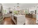 Modern kitchen with a large center island, stainless steel appliances, and hardwood floors at 19061 Eagle Ridge Dr, Golden, CO 80401