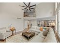 Spacious living room featuring high ceilings, a cozy fireplace, and lots of natural light at 19061 Eagle Ridge Dr, Golden, CO 80401