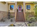 Inviting entry with a charming red door, stone accents and a beautiful fountain at 10703 Flagler Dr, Parker, CO 80134