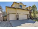Spacious three car garage with stone accents, coach lights and mature landscaping at 10703 Flagler Dr, Parker, CO 80134