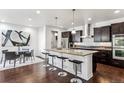 Spacious kitchen with dark brown cabinets, granite countertops, and stainless steel appliances at 9167 E 35Th Ave, Denver, CO 80238