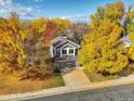Stunning aerial view of a charming home surrounded by vibrant fall foliage and blue sky, nestled in a beautiful neighborhood at 10971 Bryant St, Westminster, CO 80234
