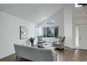 Bright and airy living room features vaulted ceilings, hardwood floors, modern furnishings, and large windows at 10971 Bryant St, Westminster, CO 80234