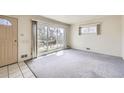 Bright living room with large windows, featuring neutral walls and flooring at 10731 Rosalie Dr, Northglenn, CO 80233