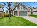 Charming two-story home with a well-manicured lawn and a two-car garage, partially obscured by a tree at 1474 E Weldona Way, Superior, CO 80027