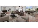 Open concept living room with hardwood floors, comfortable seating, and a view of the city at 740 N Pearl St # 606, Denver, CO 80203