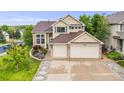Charming two-story home featuring a well-manicured front yard, brick accents, and an attached two-car garage at 22428 Quail Run Ln, Parker, CO 80138