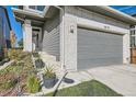 Two-story home featuring a well-manicured lawn, white brick accents and an attached two-car garage at 6893 Decatur St, Denver, CO 80221