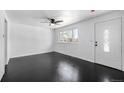 Bright living room showcasing hardwood floors, a large window, and fresh paint at 7977 Durango St, Denver, CO 80221