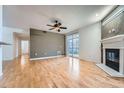 Spacious living room with hardwood floors, fireplace, and access to balcony at 3875 S Dayton St # 107, Aurora, CO 80014