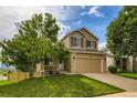 Charming two-story home with a well-manicured lawn, inviting curb appeal, and a two car garage at 11363 Latigo Ln, Parker, CO 80138