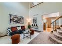 Open-concept living room boasts vaulted ceilings, a neutral color palette, and is nicely decorated at 11363 Latigo Ln, Parker, CO 80138