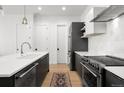 Contemporary kitchen featuring sleek cabinetry, stainless steel appliances, and a subway tile backsplash at 1250 W Osceola St # 2, Denver, CO 80204