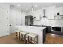 Modern kitchen with stainless steel appliances, white countertops, and a kitchen island with seating at 1250 W Osceola St # 2, Denver, CO 80204