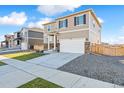 Charming two-story home showcasing a well-manicured lawn, a two-car garage, and tidy landscaping at 4732 Windmill Dr, Brighton, CO 80601
