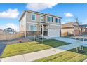 Two-story home featuring neutral siding, stone accents, well-kept lawn, and a two car garage at 4732 Windmill Dr, Brighton, CO 80601
