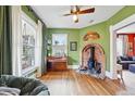 Cozy living room featuring wood floors, brick fireplace, and large windows with natural light at 91 S Sherman St, Denver, CO 80209