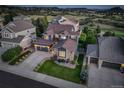 Lovely aerial view of a blue home with a manicured lawn and stone detailing in an attractive neighborhood at 1176 Dales Pony Dr, Castle Rock, CO 80104