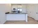 Modern kitchen with stainless steel appliances, light wood floors and a breakfast bar area at 6562 Arbor Blvd # 4, Thornton, CO 80602