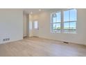Bright living room featuring natural light, light wood flooring, and neutral walls at 6562 Arbor Blvd # 4, Thornton, CO 80602
