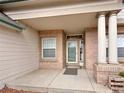 Inviting entryway with brick accents, classic columns, and a glass-paneled door at 412 E 131St Ave, Thornton, CO 80241