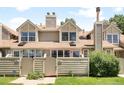 Well-maintained home featuring a manicured lawn, secure fenced yard, and welcoming entryway at 7373 E Iowa Ave # 1124, Denver, CO 80231