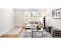 Bright living room boasts ample natural light, modern furnishings, and a stylish decorative rug at 7373 E Iowa Ave # 1124, Denver, CO 80231