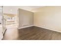 Inviting living room with dark wood floors and neutral walls at 11302 Tumbleweed Way, Parker, CO 80138