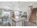 Open kitchen with a center island, stainless steel dishwasher, and seamless flow into the dining and living areas at 1907 Mount Monroe Dr, Berthoud, CO 80513