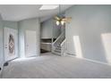 Bright living room features a vaulted ceiling, skylight, fresh paint and carpeted floors at 11610 Hooker St, Westminster, CO 80031